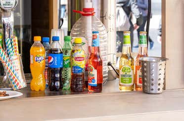 An assortment of beverages from recognizable brands, including Fanta, Pepsi, Sprite, and Lipton.